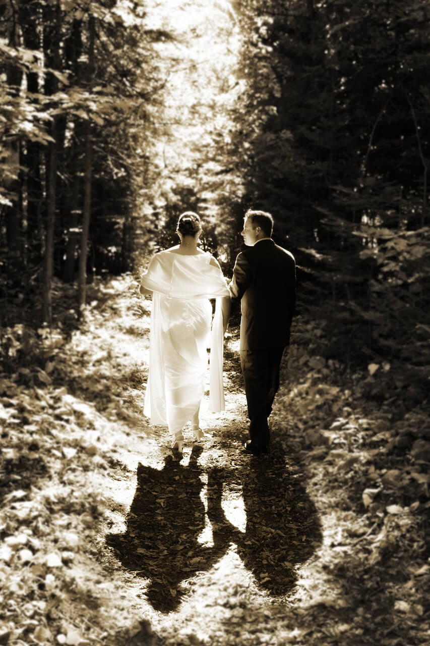 Bride and groom walking a trail