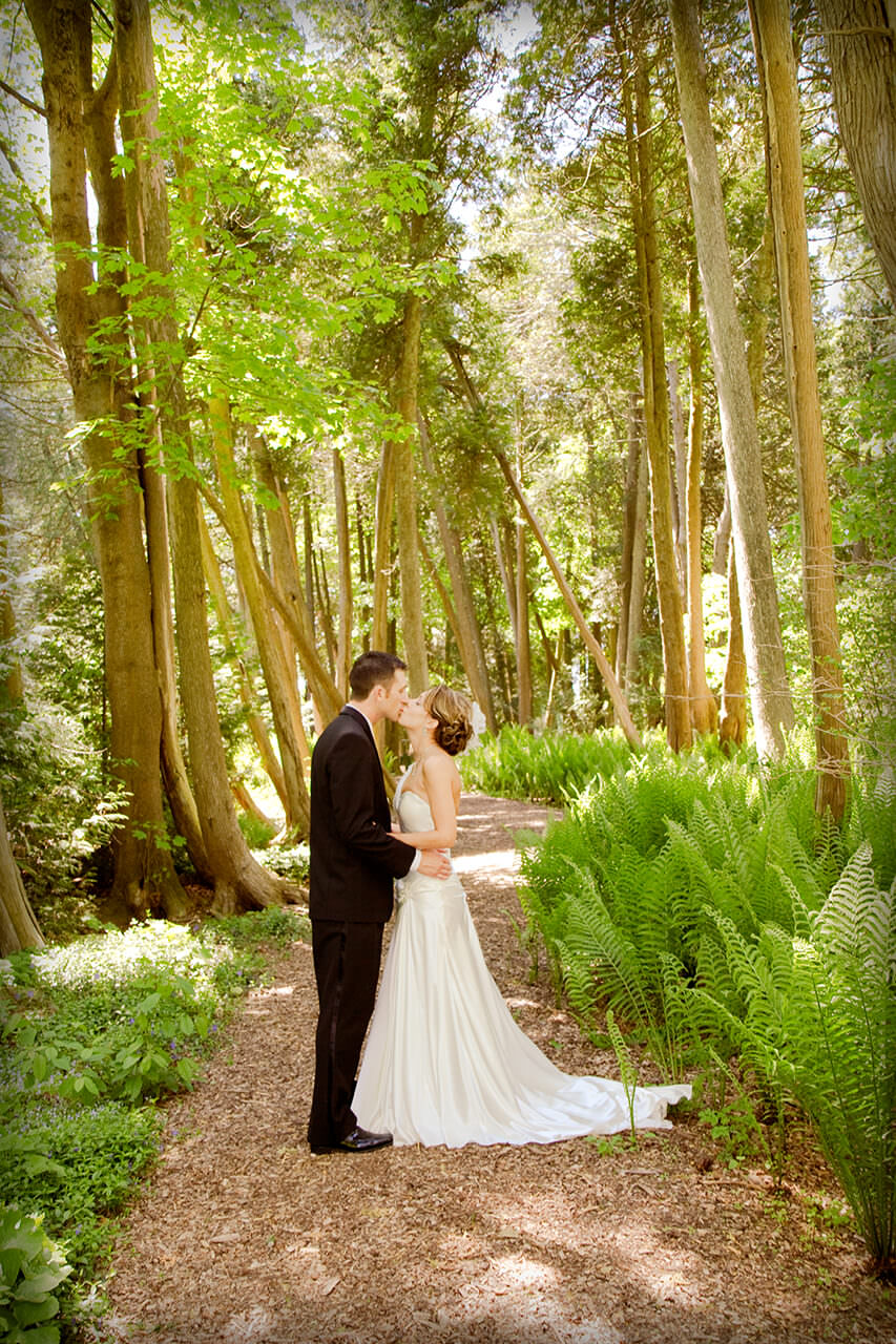 Wedding couple kissing in the woods