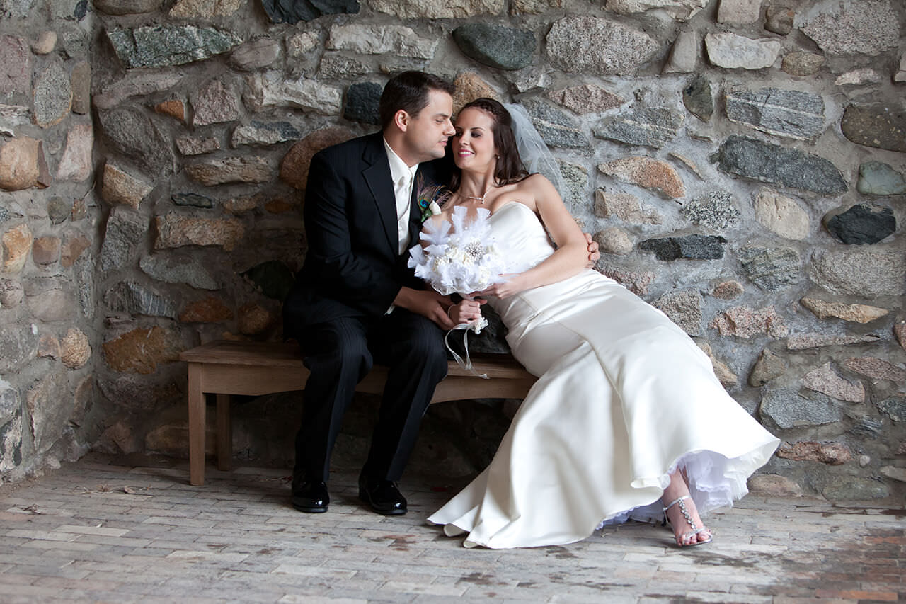 Bride and groom taking a break on a bench