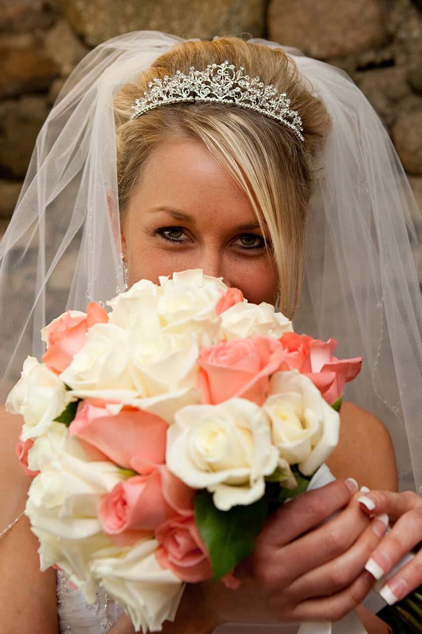 Bride peeking over her bouquet