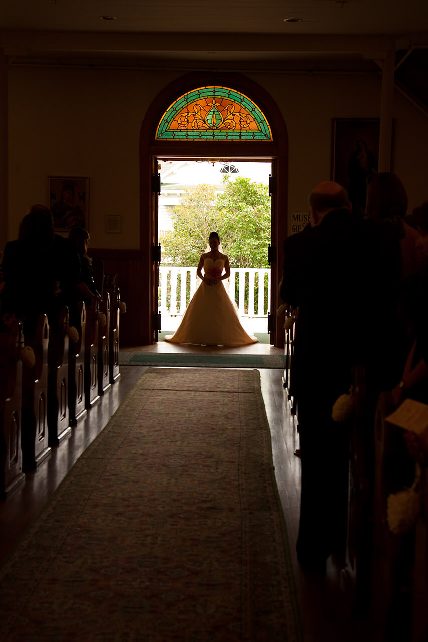 Bride entering Ste. Anne Catholic Church on Mackinac Island