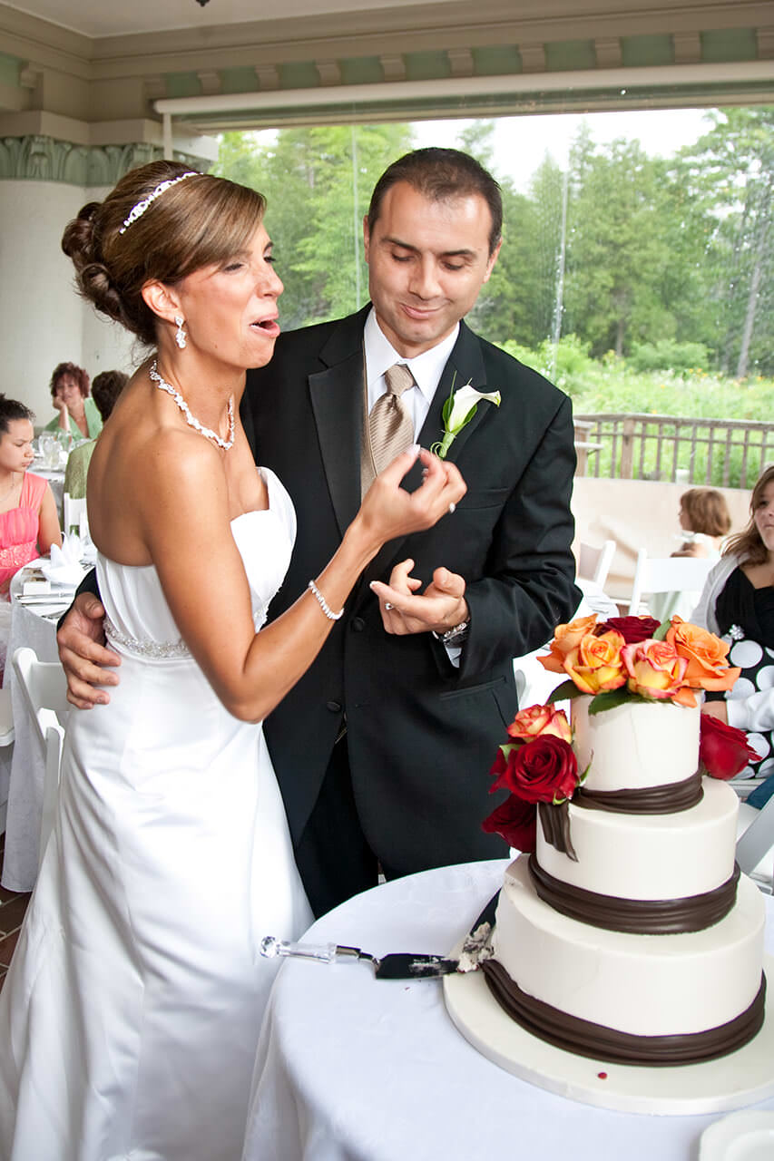 Bride and groom tasting the wedding cake
